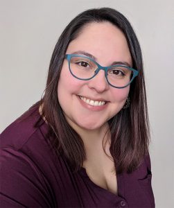 Seaglass Psychology Edmonton Psychologist. Close-up picture of Consuelo Arriagada, smiling at the camera.